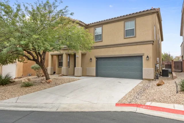 Front exterior with two-car garage and desert landscaping