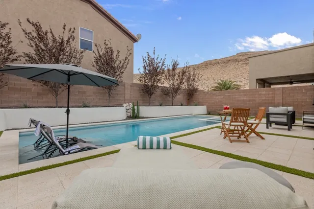 Pool deck with lounge chairs and cabana umbrella