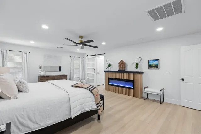 Primary bedroom with linear fireplace